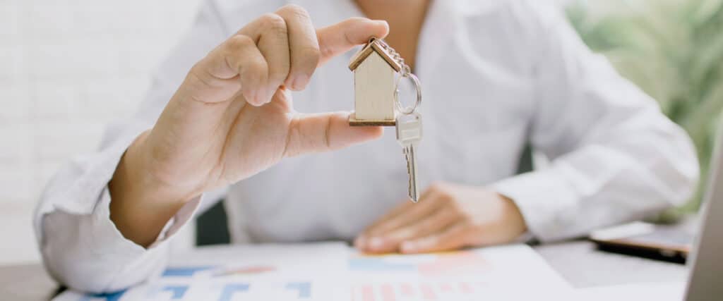 real estate investment trust agent holding house keys